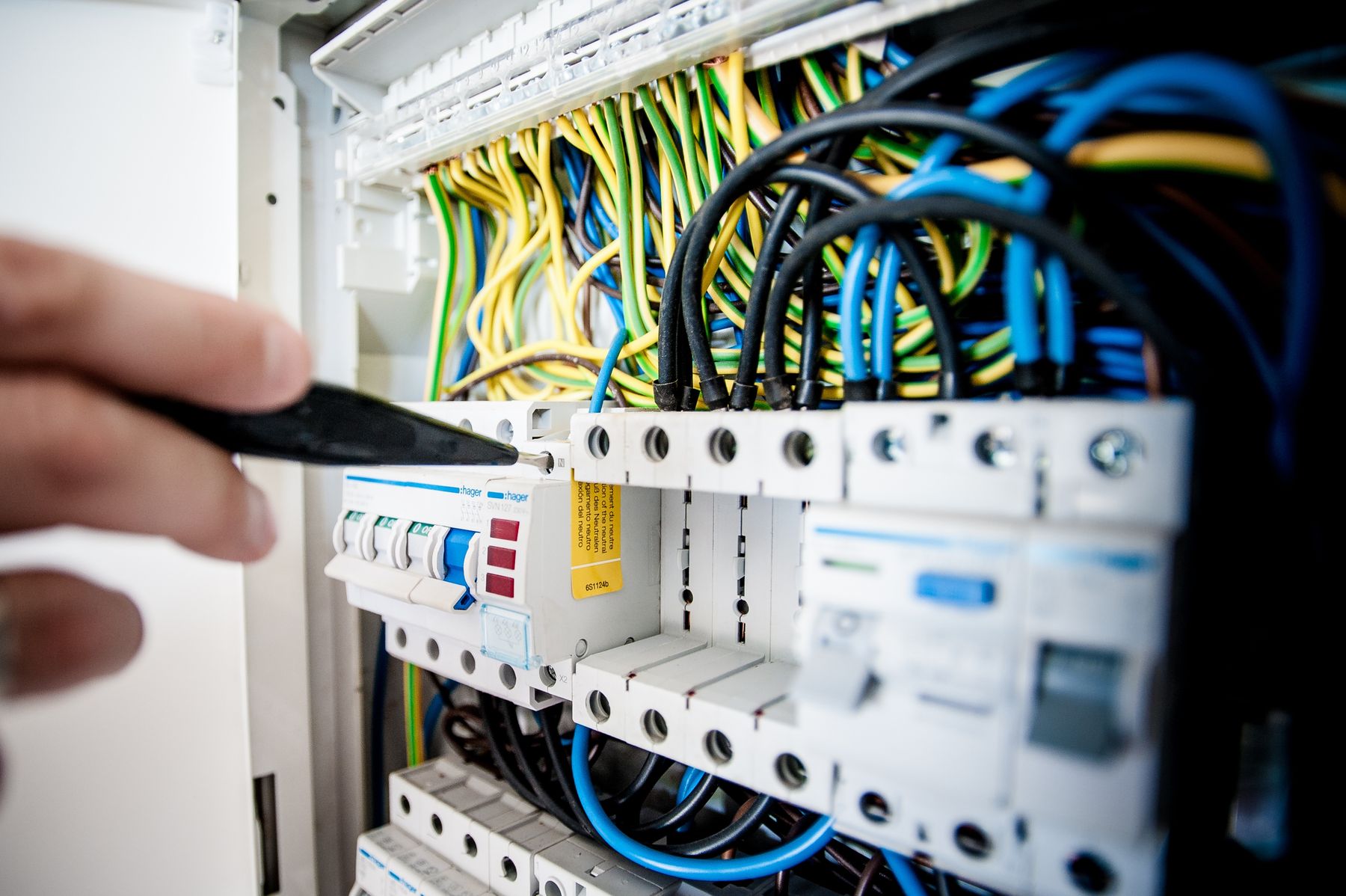 Electrician working on an electrical switchboard